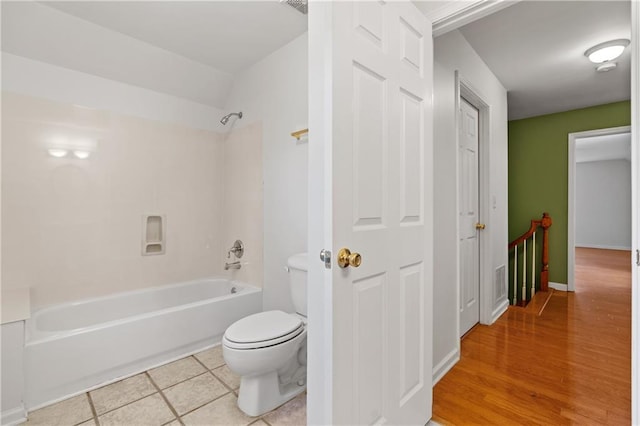 bathroom with tile patterned flooring,  shower combination, and toilet