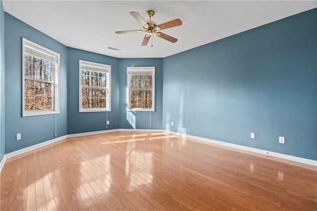 spare room featuring light wood-type flooring and ceiling fan