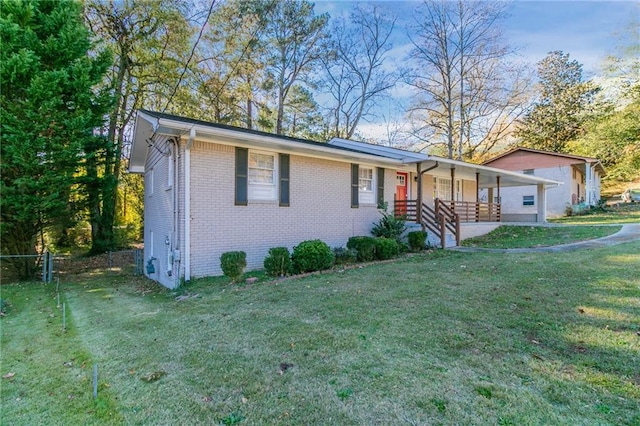 view of front of property with covered porch and a front yard