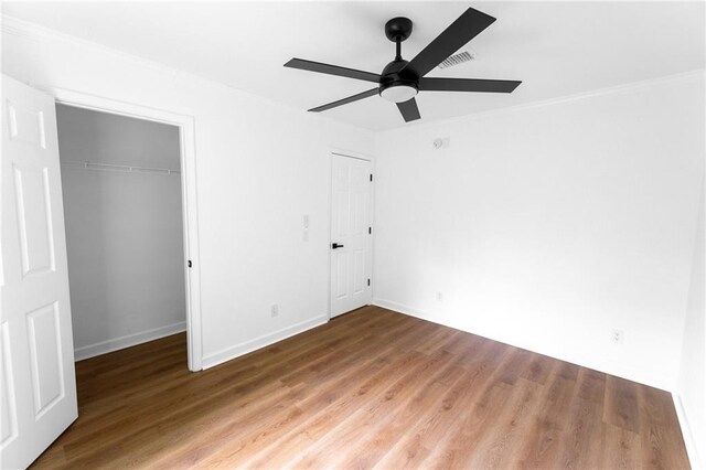 1111 Osborne St SW, Atlanta, GA 30310 - unfurnished bedroom featuring a ceiling fan, wood finished floors, a closet, baseboards, and visible vents