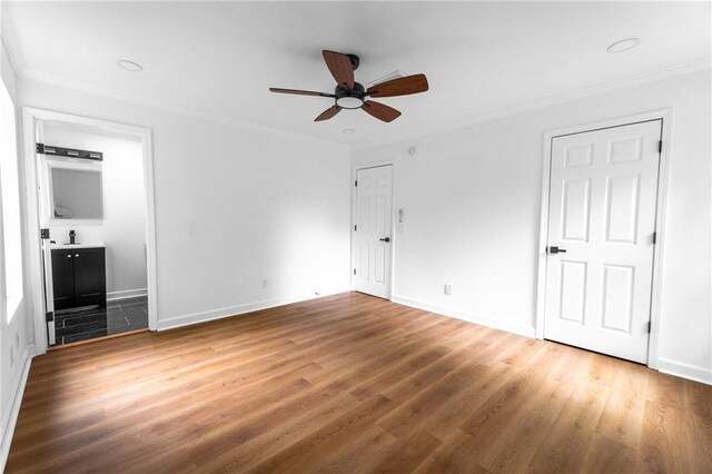 1111 Osborne St SW, Atlanta, GA 30310 - unfurnished bedroom featuring a ceiling fan, wood finished floors, baseboards, ensuite bath, and ornamental molding