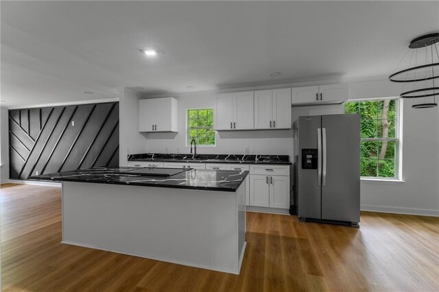 1111 Osborne St SW, Atlanta, GA 30310 - kitchen featuring white cabinets, wood finished floors, a sink, a center island, and stainless steel fridge