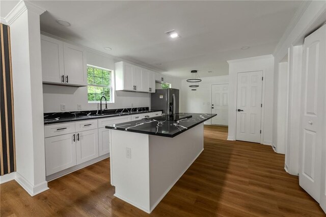 1111 Osborne St SW, Atlanta, GA 30310 - kitchen featuring white cabinets, dark wood-style floors, dark countertops, a sink, and stainless steel fridge