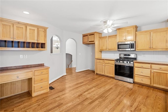 412 Gray Fox Dr, Canton, GA 30114 - kitchen with stainless steel appliances, light brown cabinetry, arched walkways, a ceiling fan, and recessed lighting