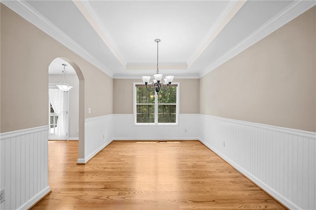 412 Gray Fox Dr, Canton, GA 30114 - unfurnished room featuring wainscoting, a chandelier, arched walkways, light wood finished floors, and a raised ceiling