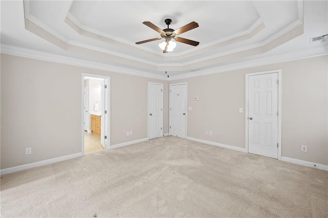 412 Gray Fox Dr, Canton, GA 30114 - unfurnished bedroom with a tray ceiling, two closets, light colored carpet, ornamental molding, and connected bathroom