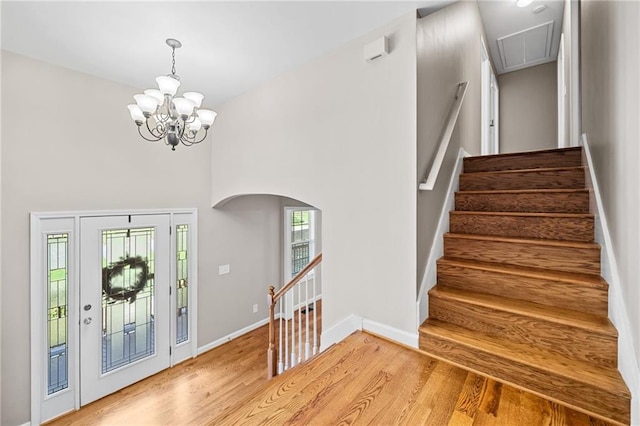 412 Gray Fox Dr, Canton, GA 30114 - entryway featuring light wood-style floors, a chandelier, arched walkways, a towering ceiling, and stairway