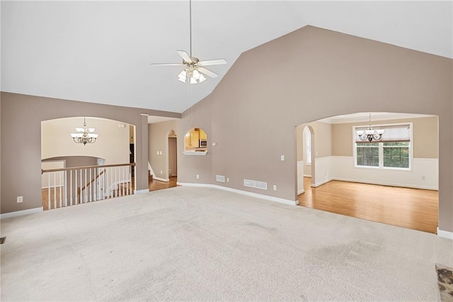 412 Gray Fox Dr, Canton, GA 30114 - spare room with a chandelier, carpet flooring, arched walkways, and high vaulted ceiling