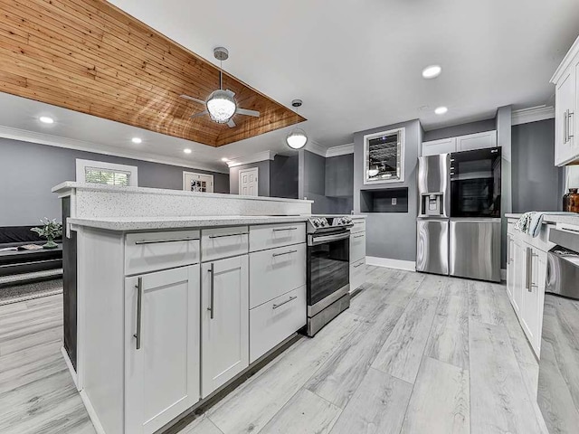 kitchen featuring a center island, hanging light fixtures, light wood-type flooring, white cabinets, and ornamental molding