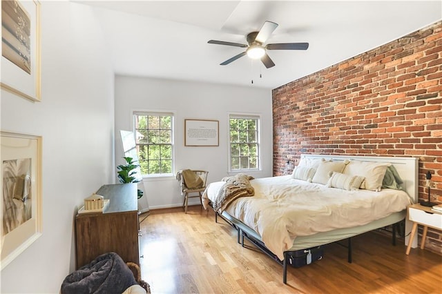 3675 Peachtree Rd NE Unit 24, Atlanta, GA 30319 - bedroom featuring brick wall, light wood-type flooring, and ceiling fan