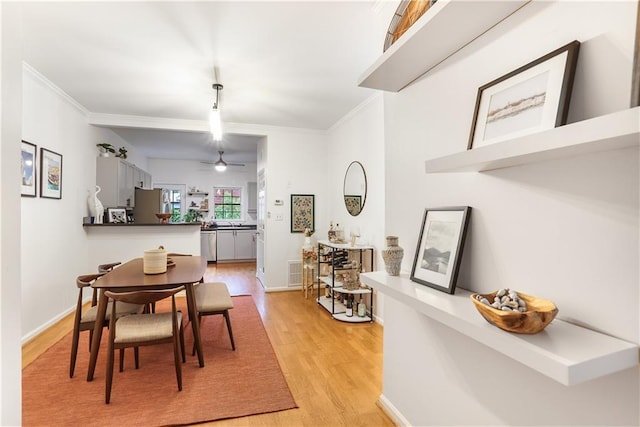 3675 Peachtree Rd NE Unit 24, Atlanta, GA 30319 - dining area with light wood-style floors, crown molding, and a ceiling fan