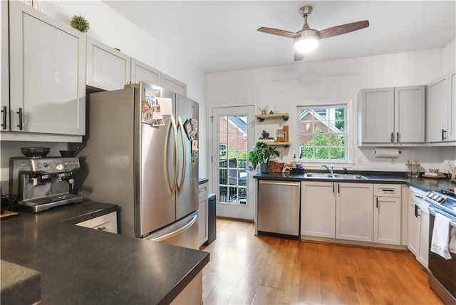 3675 Peachtree Rd NE Unit 24, Atlanta, GA 30319 - kitchen featuring appliances with stainless steel finishes, dark countertops, light wood-type flooring, and a ceiling fan