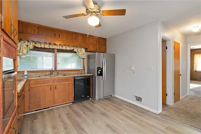 kitchen featuring light wood-type flooring, ceiling fan, stainless steel appliances, and sink