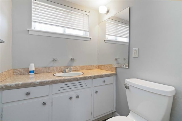 bathroom with toilet and vanity