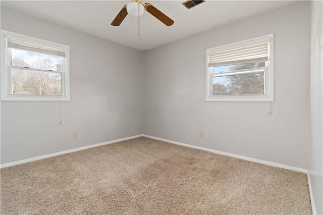 spare room with ceiling fan and carpet flooring