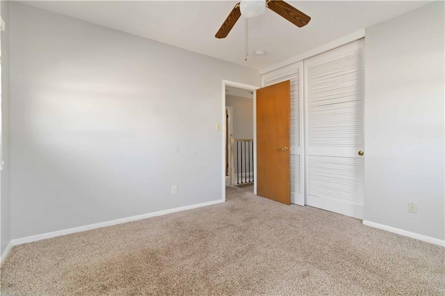 unfurnished bedroom featuring ceiling fan, a closet, and carpet floors