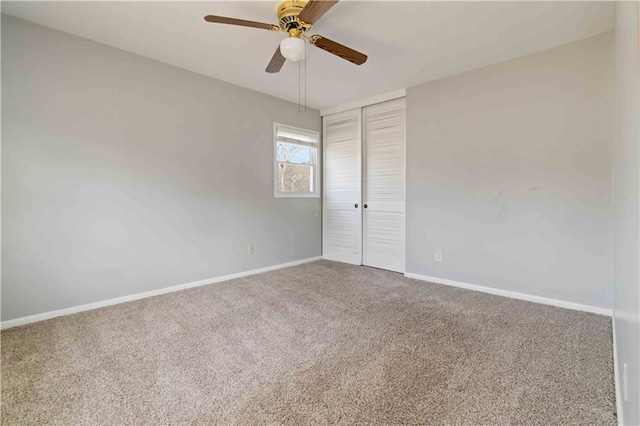 empty room featuring ceiling fan and carpet floors