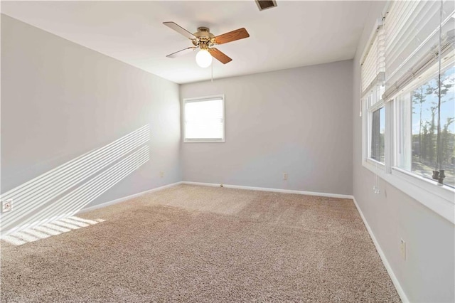 carpeted empty room featuring ceiling fan