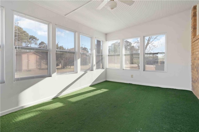 unfurnished sunroom featuring ceiling fan