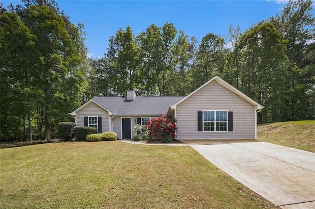 single story home featuring a chimney, driveway, and a front yard