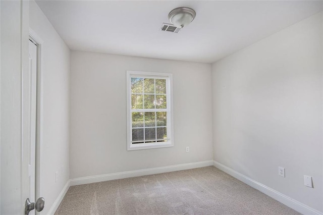 carpeted empty room with baseboards and visible vents