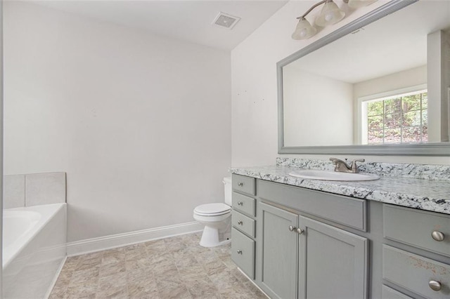 full bathroom with a bath, visible vents, vanity, baseboards, and toilet