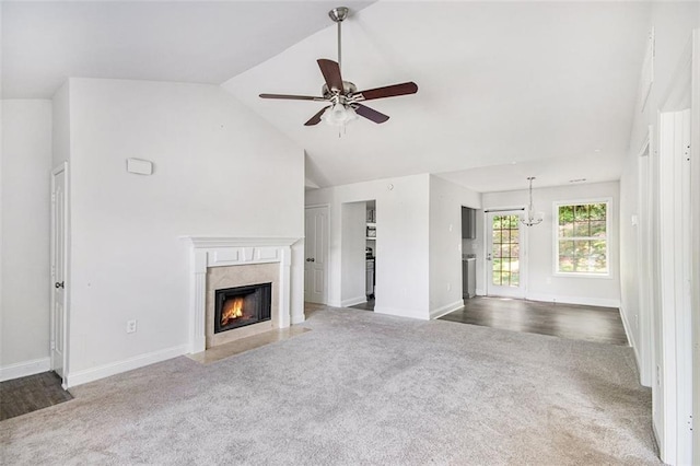 unfurnished living room with carpet flooring, ceiling fan, baseboards, and a high end fireplace