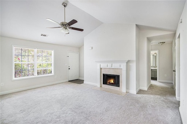 unfurnished living room featuring carpet flooring, ceiling fan, a premium fireplace, lofted ceiling, and visible vents
