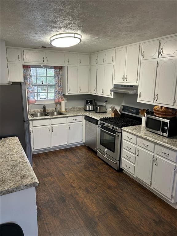 kitchen featuring white cabinetry, sink, dark wood-type flooring, and appliances with stainless steel finishes