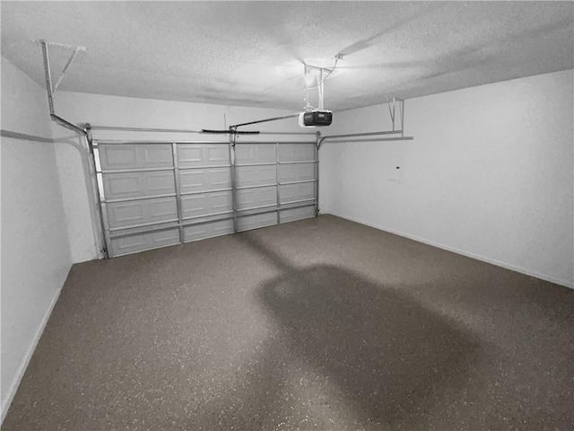 garage with baseboards and a garage door opener