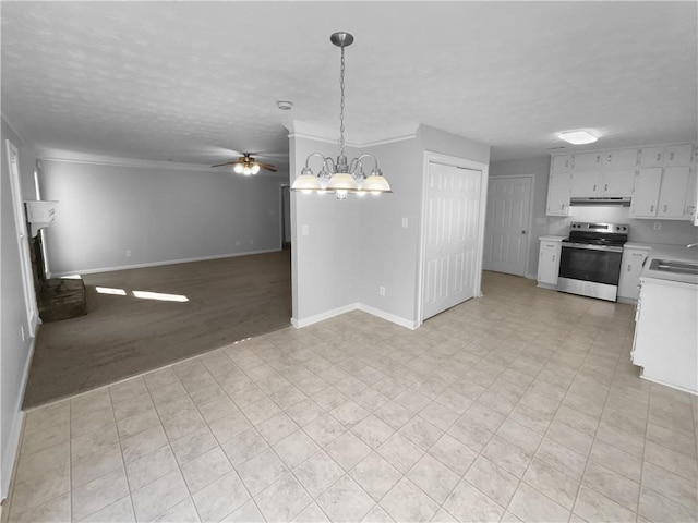 kitchen with stainless steel electric range oven, open floor plan, light countertops, under cabinet range hood, and a sink