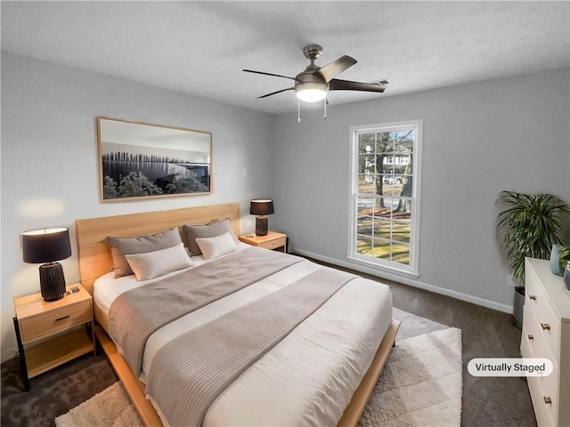 bedroom featuring ceiling fan, dark carpet, and baseboards