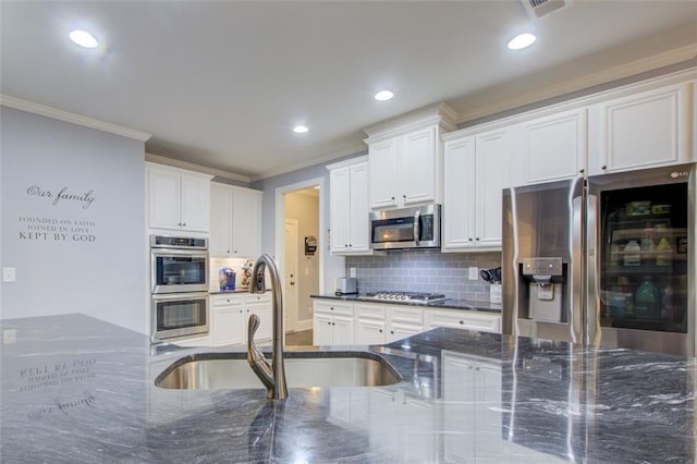 401 Night Hawk Ct, Canton, GA 30114 - kitchen with stainless steel appliances, a sink, ornamental molding, backsplash, and recessed lighting