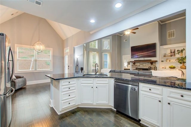 401 Night Hawk Ct, Canton, GA 30114 - kitchen featuring a sink, stainless steel appliances, open floor plan, dark stone countertops, and lofted ceiling