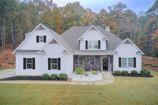 401 Night Hawk Ct, Canton, GA 30114 - view of front of home with covered porch, a front yard, a chimney, and a shingled roof
