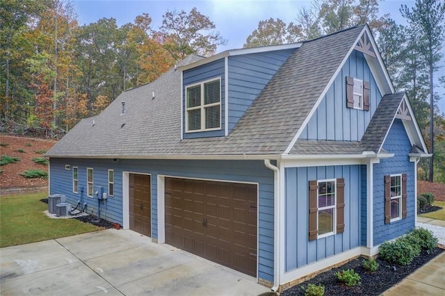 401 Night Hawk Ct, Canton, GA 30114 - view of property exterior with board and batten siding, a garage, a shingled roof, and central AC