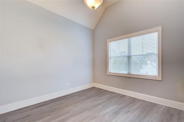 401 Night Hawk Ct, Canton, GA 30114 - spare room featuring wood finished floors, vaulted ceiling, and baseboards