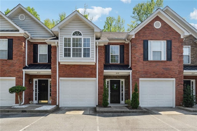 215 Morris Ln, Woodstock, GA 30188 - multi unit property with an attached garage, brick siding, driveway, a standing seam roof, and metal roof