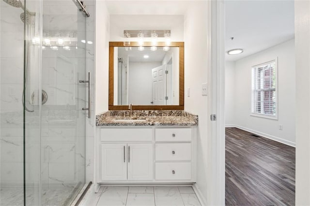 215 Morris Ln, Woodstock, GA 30188 - bathroom featuring a marble finish shower, vanity, baseboards, and marble finish floors