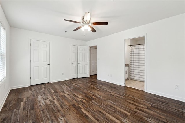 215 Morris Ln, Woodstock, GA 30188 - unfurnished bedroom with wood finished floors, baseboards, connected bathroom, and a ceiling fan