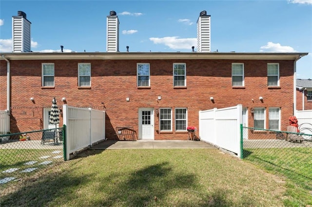 215 Morris Ln, Woodstock, GA 30188 - back of house featuring a chimney, brick siding, and a patio
