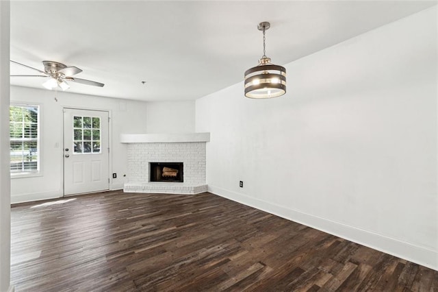 215 Morris Ln, Woodstock, GA 30188 - unfurnished living room with dark wood-type flooring, baseboards, a ceiling fan, and a brick fireplace