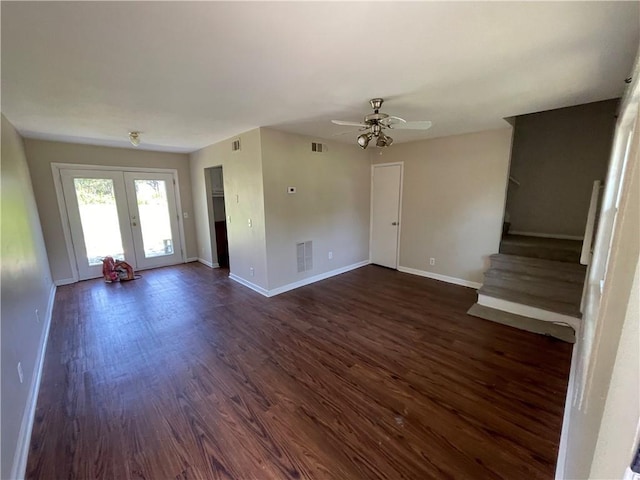 unfurnished living room featuring ceiling fan, french doors, and dark wood-type flooring