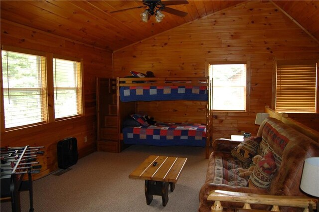 30C River Forest Pl, Suches, GA 30572 - carpeted living room featuring vaulted ceiling, plenty of natural light, a ceiling fan, wooden ceiling, and wooden walls