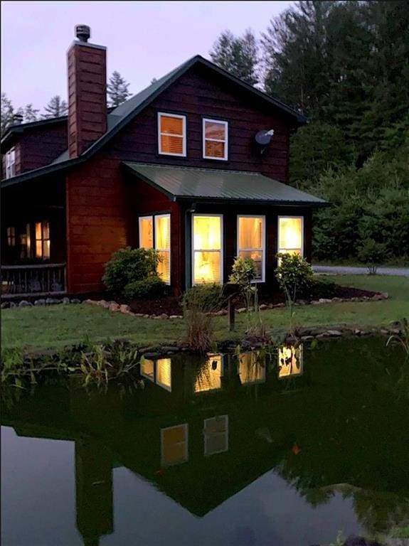 30C River Forest Pl, Suches, GA 30572 - back of property at dusk with a chimney, a yard, and metal roof