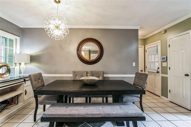 tiled dining area with a textured ceiling, ornamental molding, and a notable chandelier