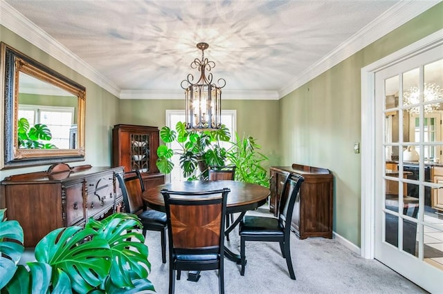 dining room featuring a chandelier, light colored carpet, and ornamental molding