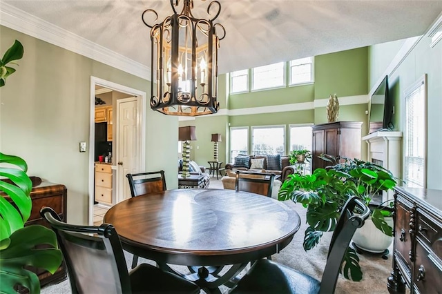 dining area with crown molding and a notable chandelier