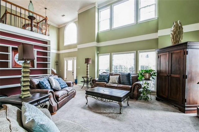 carpeted living room with crown molding, plenty of natural light, and a high ceiling