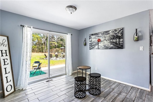interior space featuring visible vents, baseboards, and wood finished floors